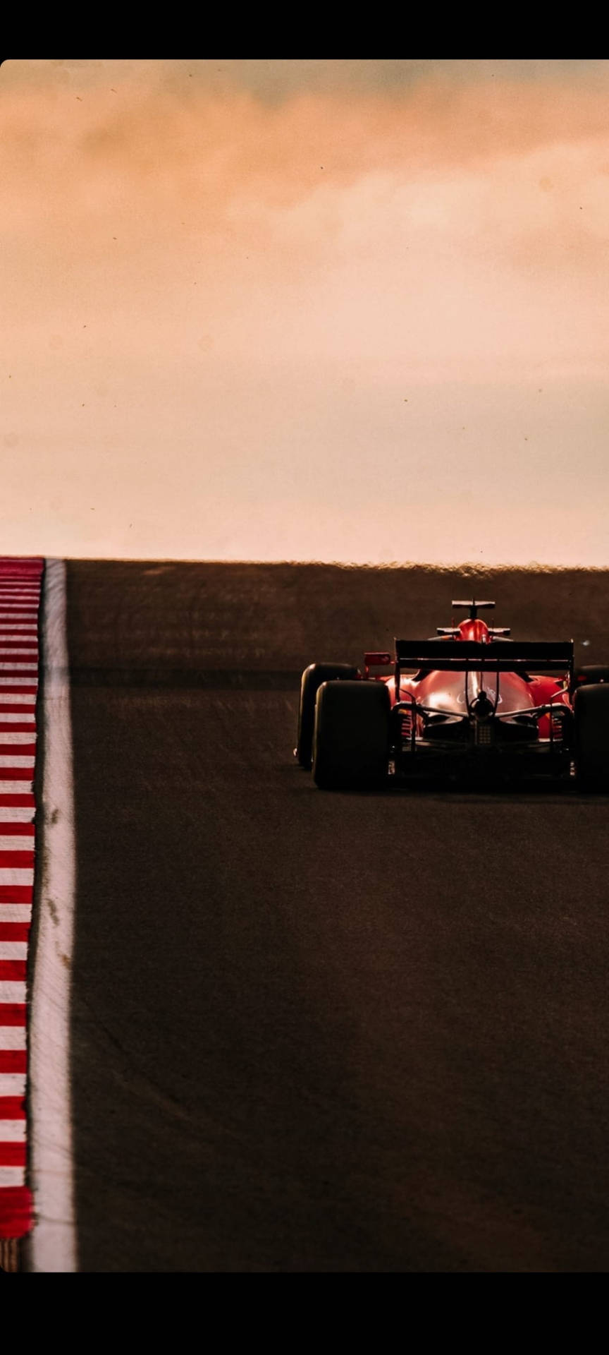 Charles Leclerc Driving Into Sunset Background