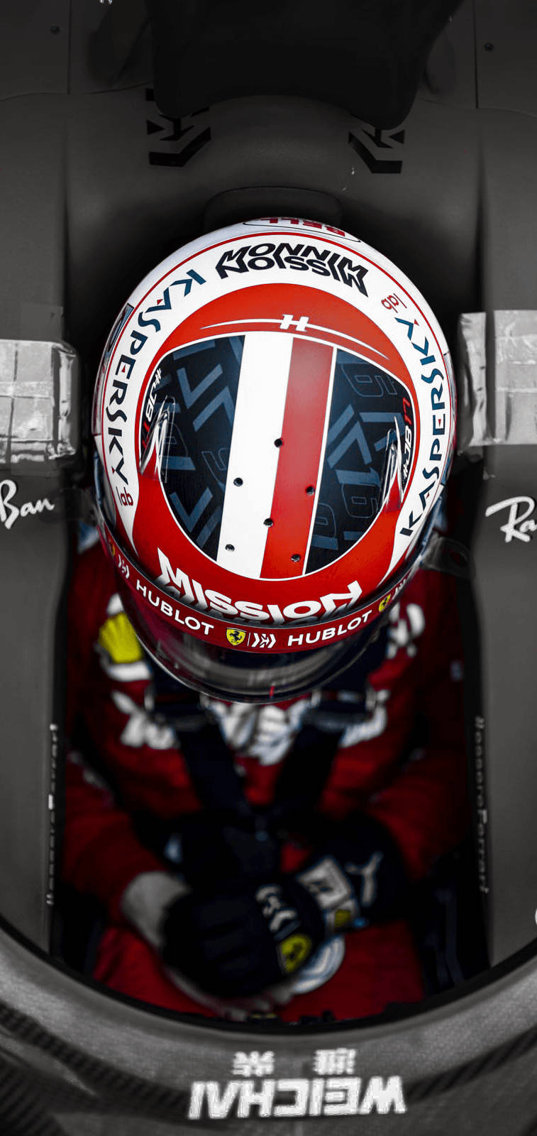 Charles Leclerc Wearing Helmet In Formula One Car Background