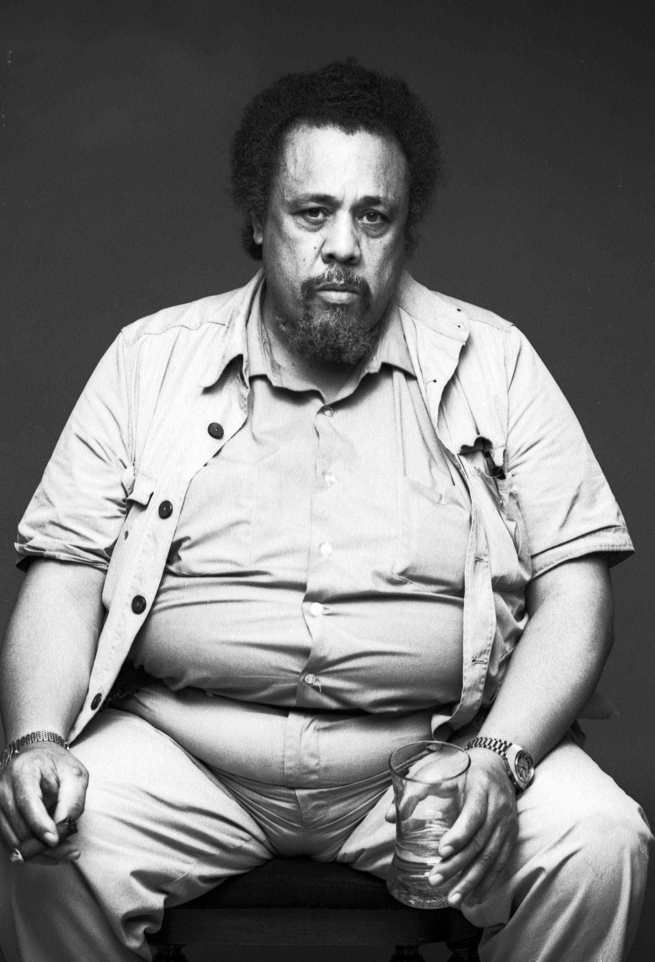 Charles Mingus Holding A Glass Background