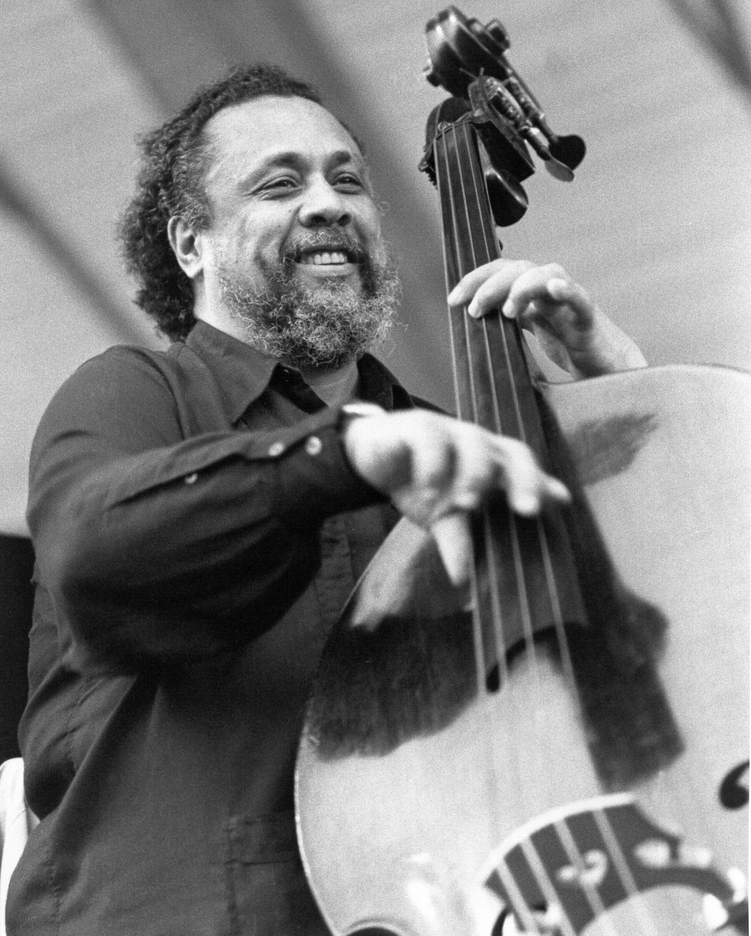 Charles Mingus Joyfully Playing Bass Guitar