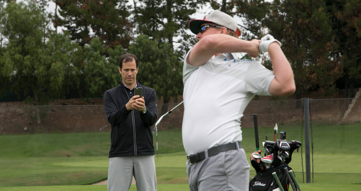 Charley Hoffman Executing A Perfect Swing On The Golf Course. Background