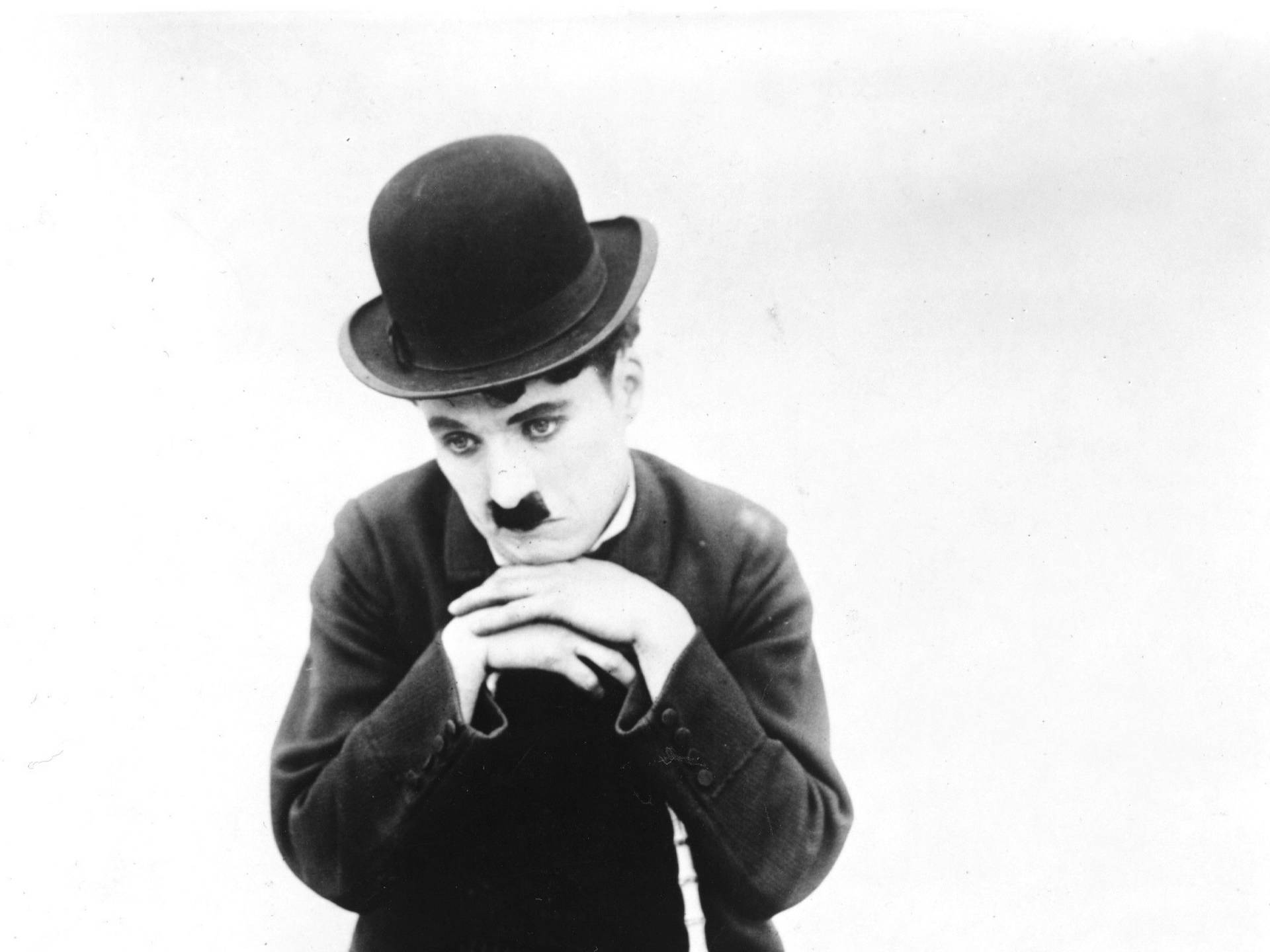 Charlie Chaplin, The Tramp, Wears His Trademark Forlorn Expression Background