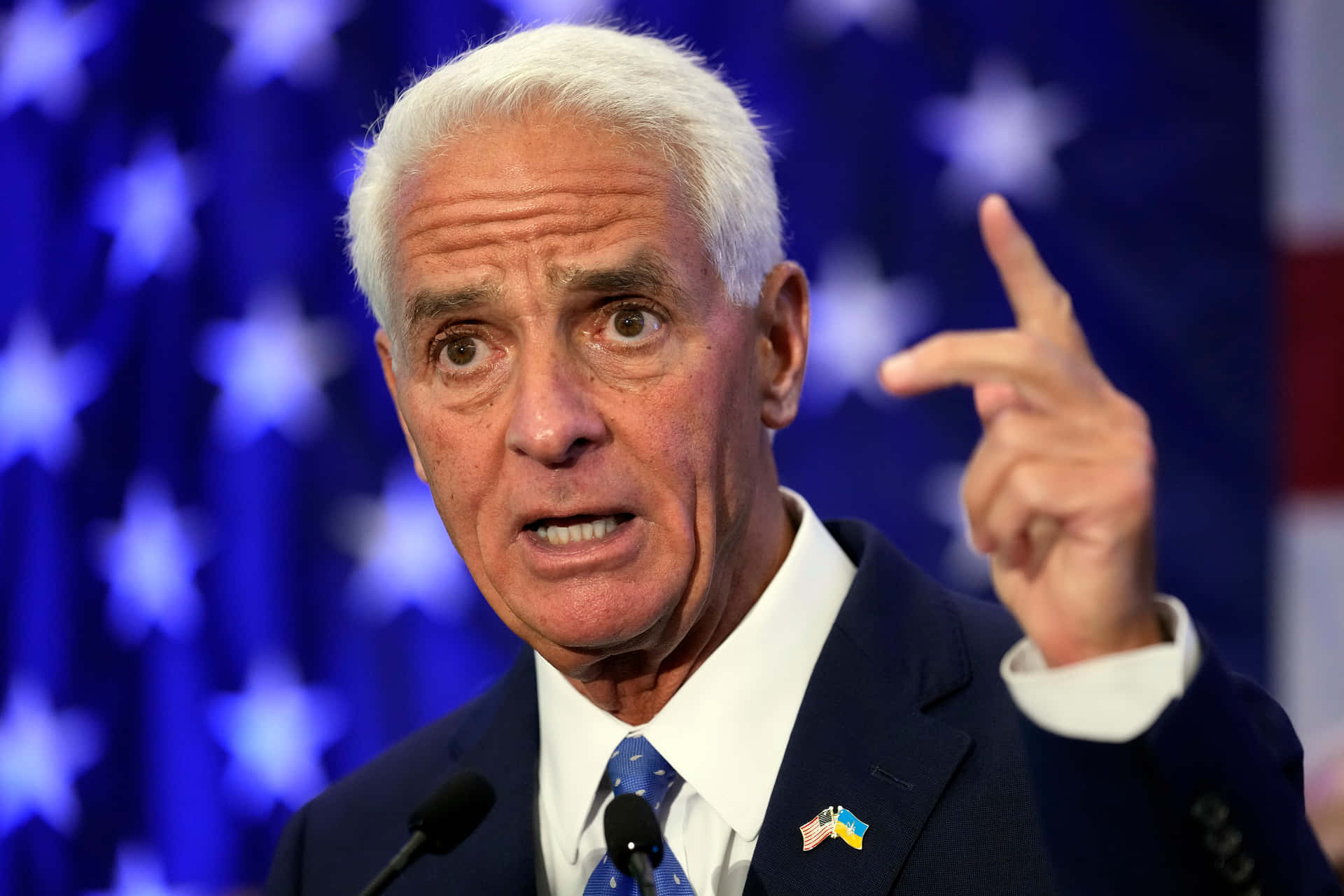 Charlie Crist Performing A Signature Hand Gesture Background