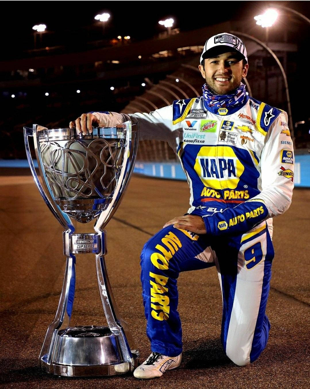 Chase Elliott Celebrating With Trophy Background