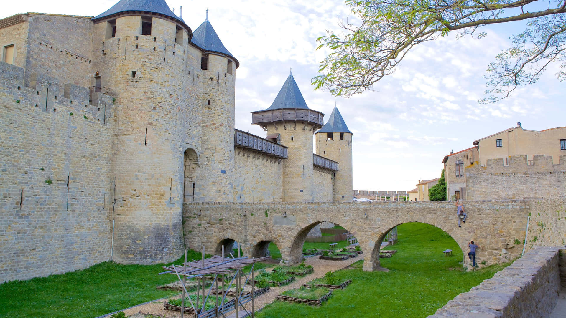 Chateau Comtal In Carcassonne During Broad Daylight Background