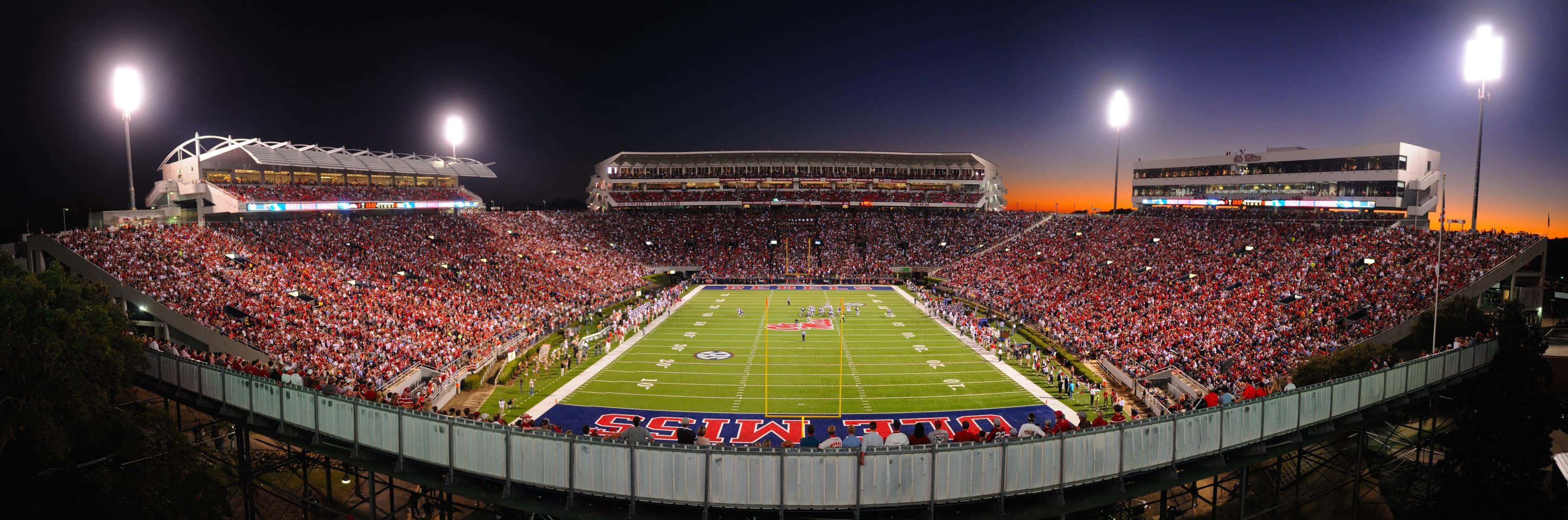 Cheering On The Rebels At The Ole Miss Stadium Background