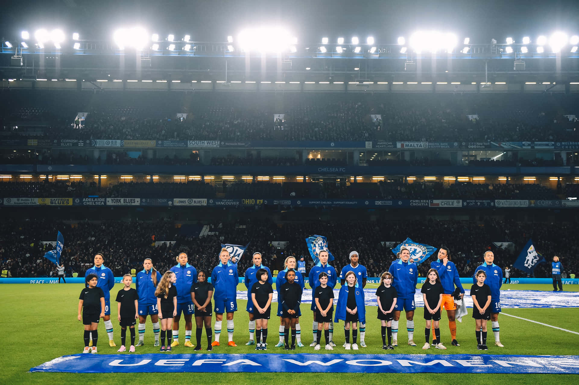 Chelsea Women's Team Pose For A Photo At The Stadium Background