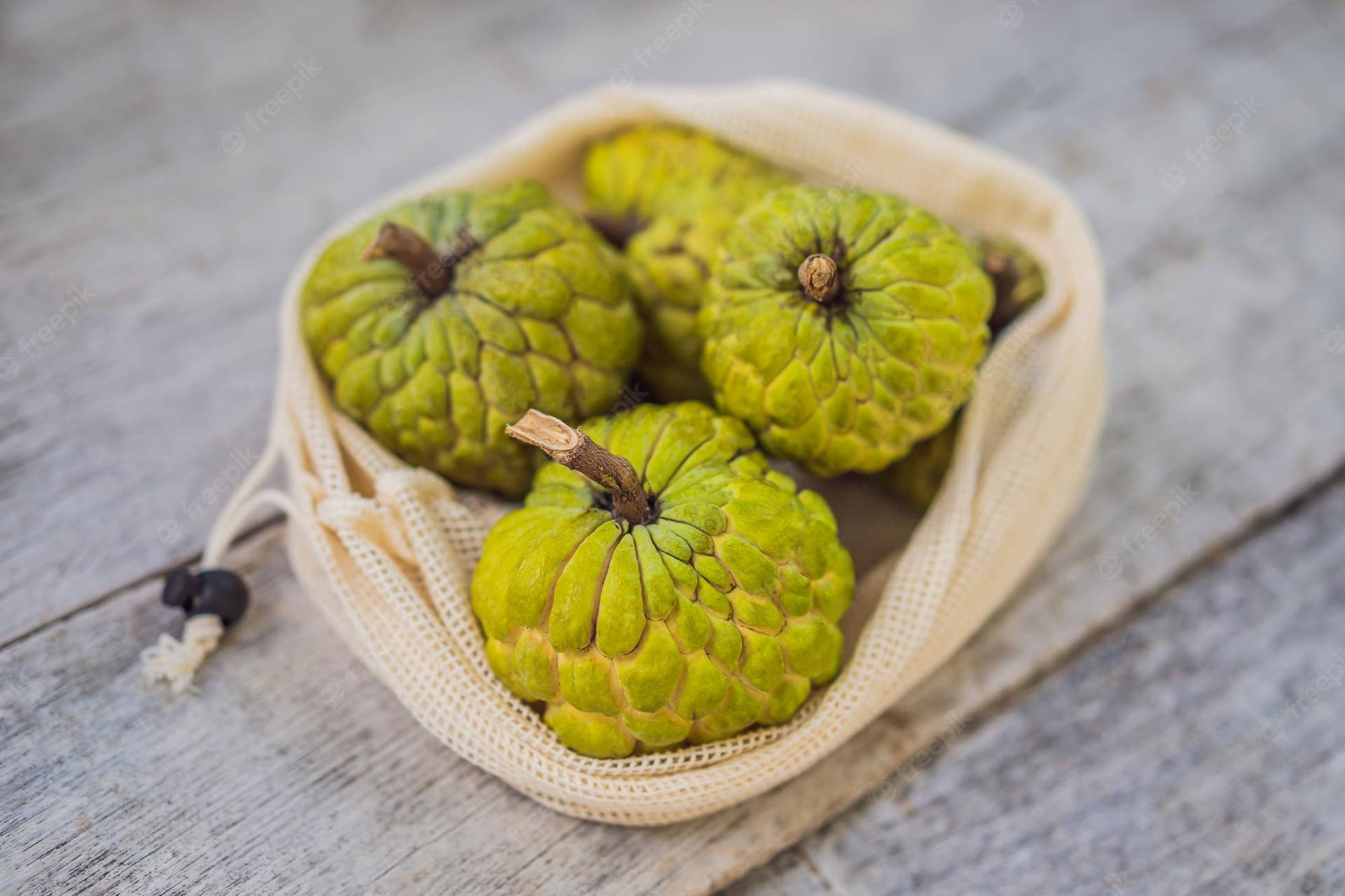 Cherimoya Fruit In Cute String Bag Background