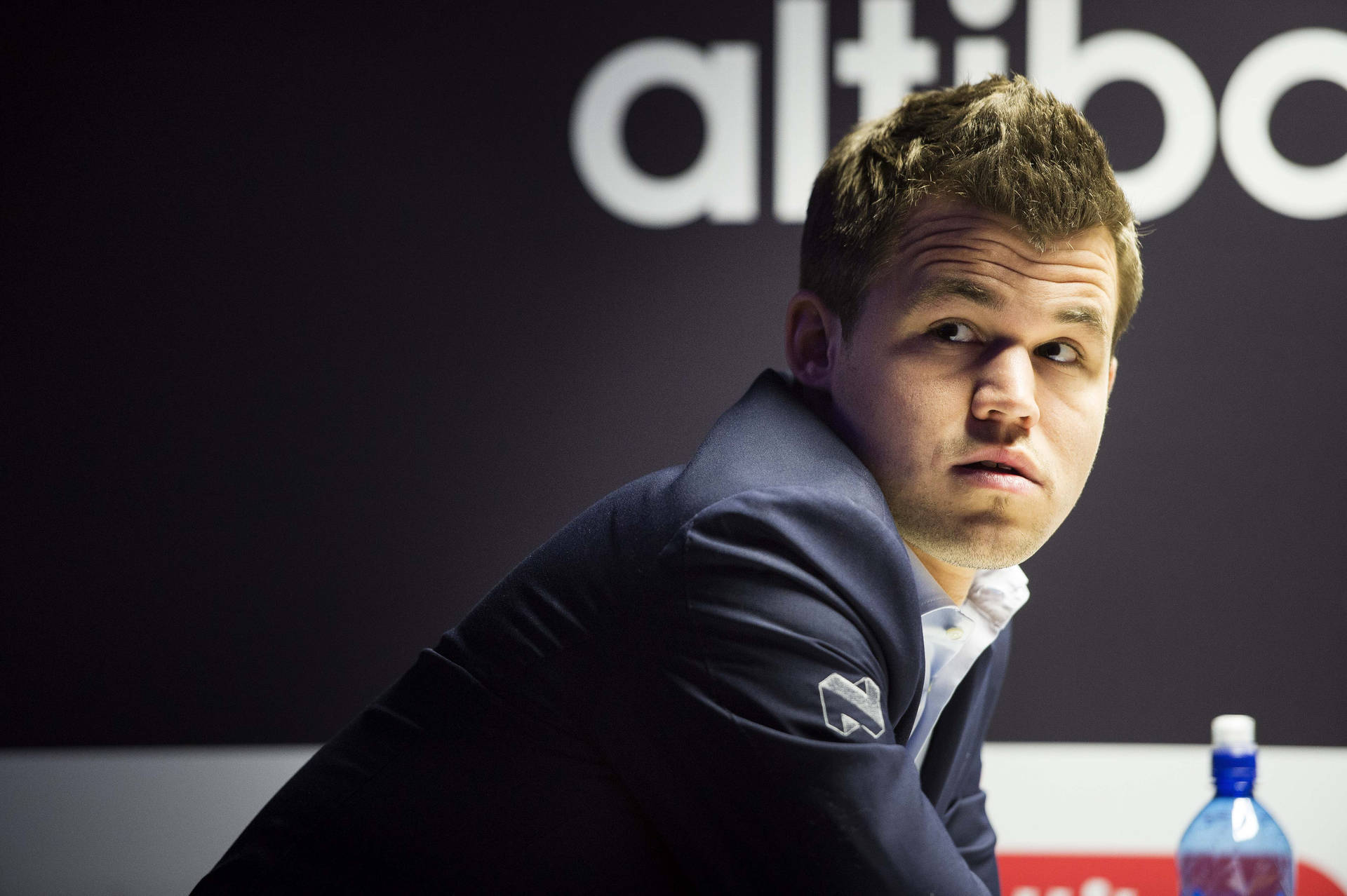 Chess Grandmaster Magnus Carlsen In Thoughtful Pose Background