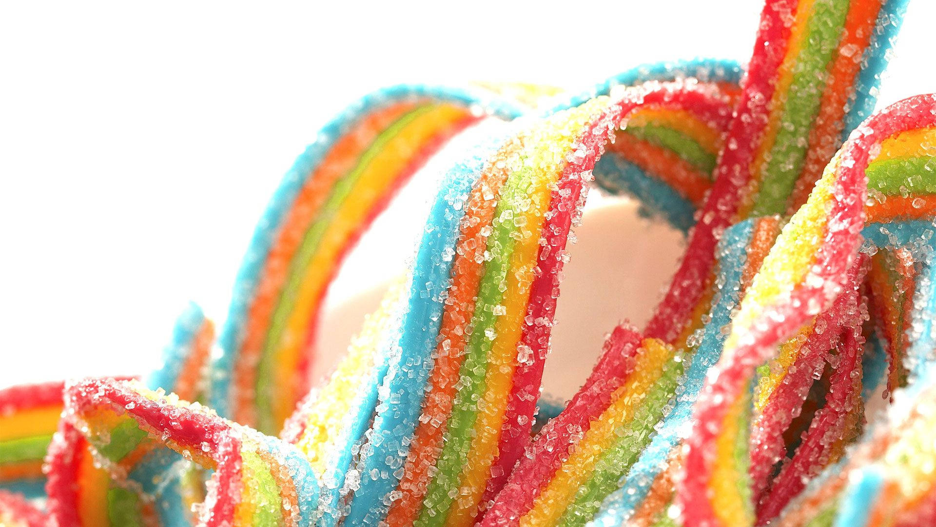 Chewy Sugar Candies In Rainbow Colors Background