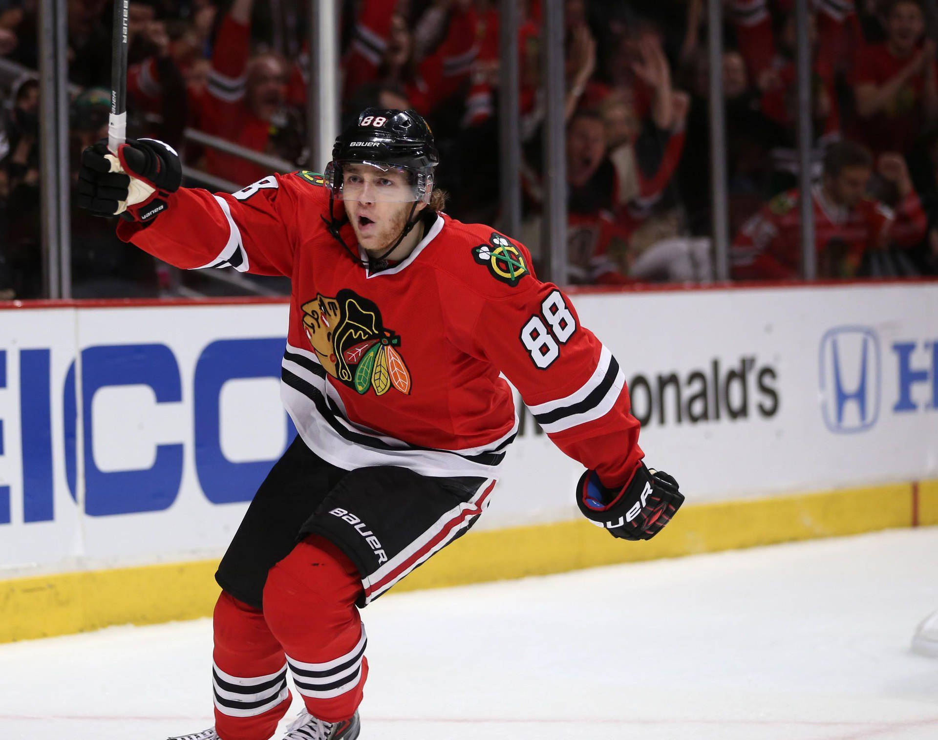 Chicago Blackhawks Star, Patrick Kane, Celebrates On Ice Background