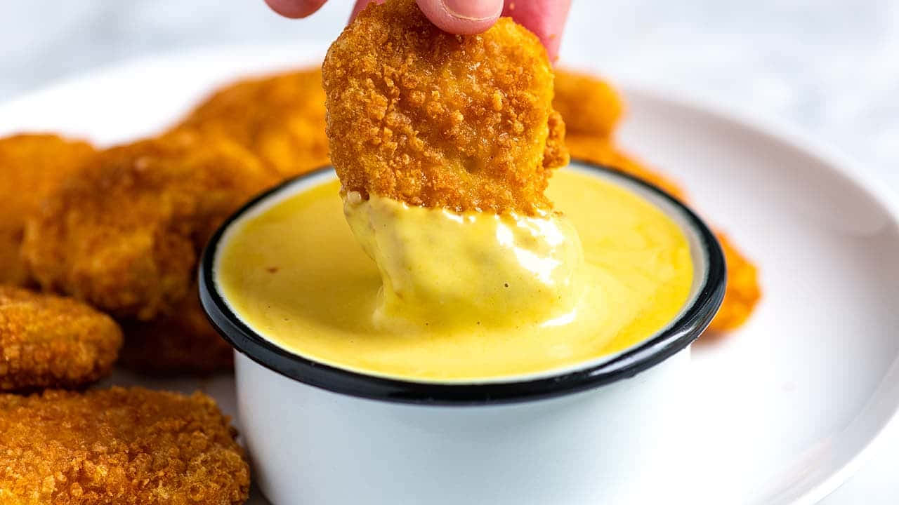 Chicken Nugget Dippingin Mustard Sauce Background