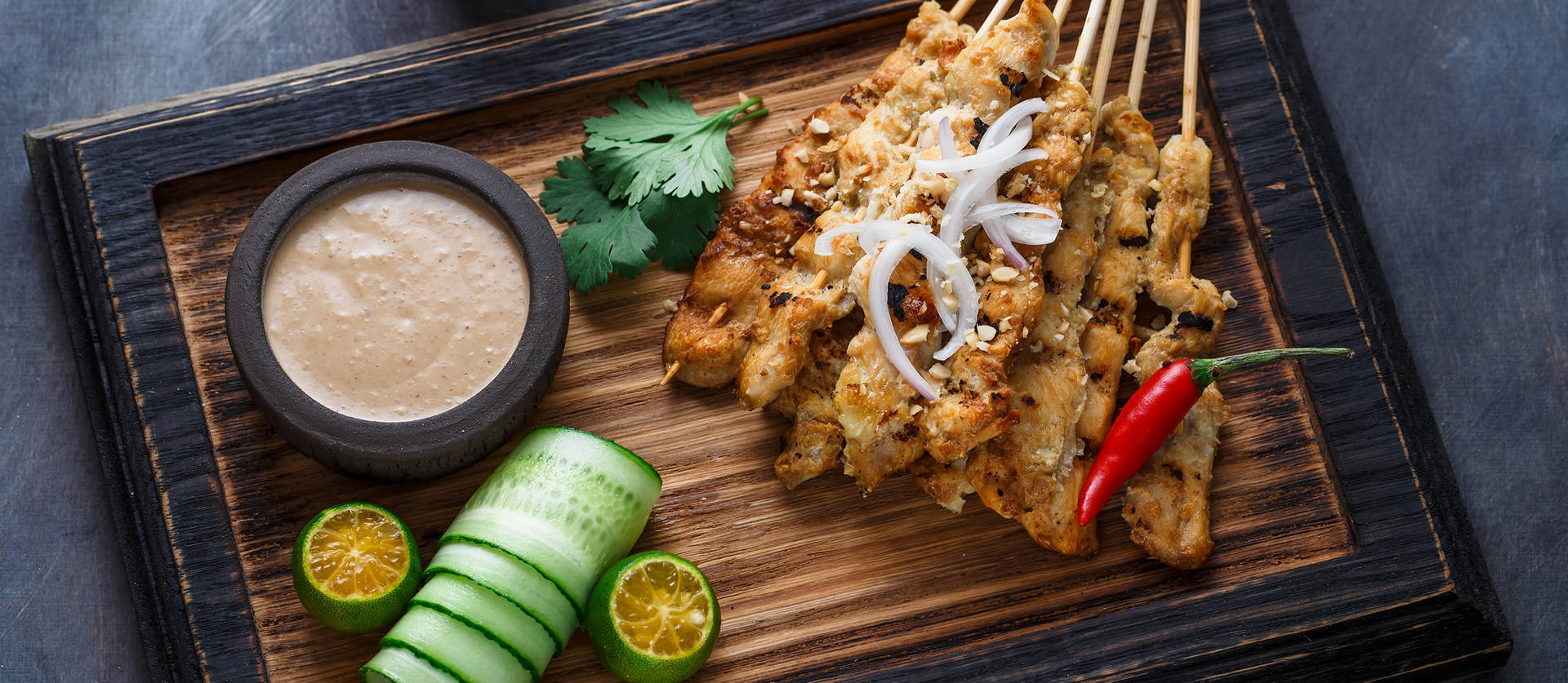 Chicken Satay On Black And Brown Wooden Tray Background