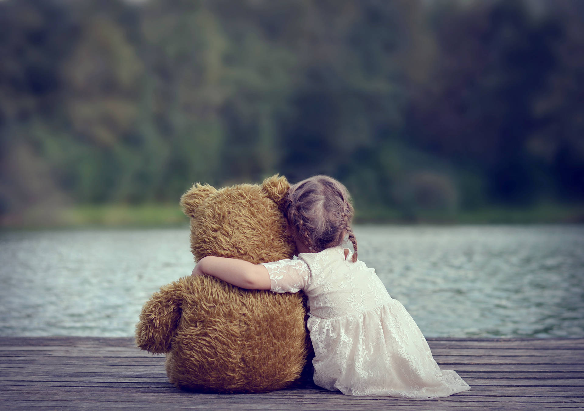 Child Hugging A Teddy Bear Background