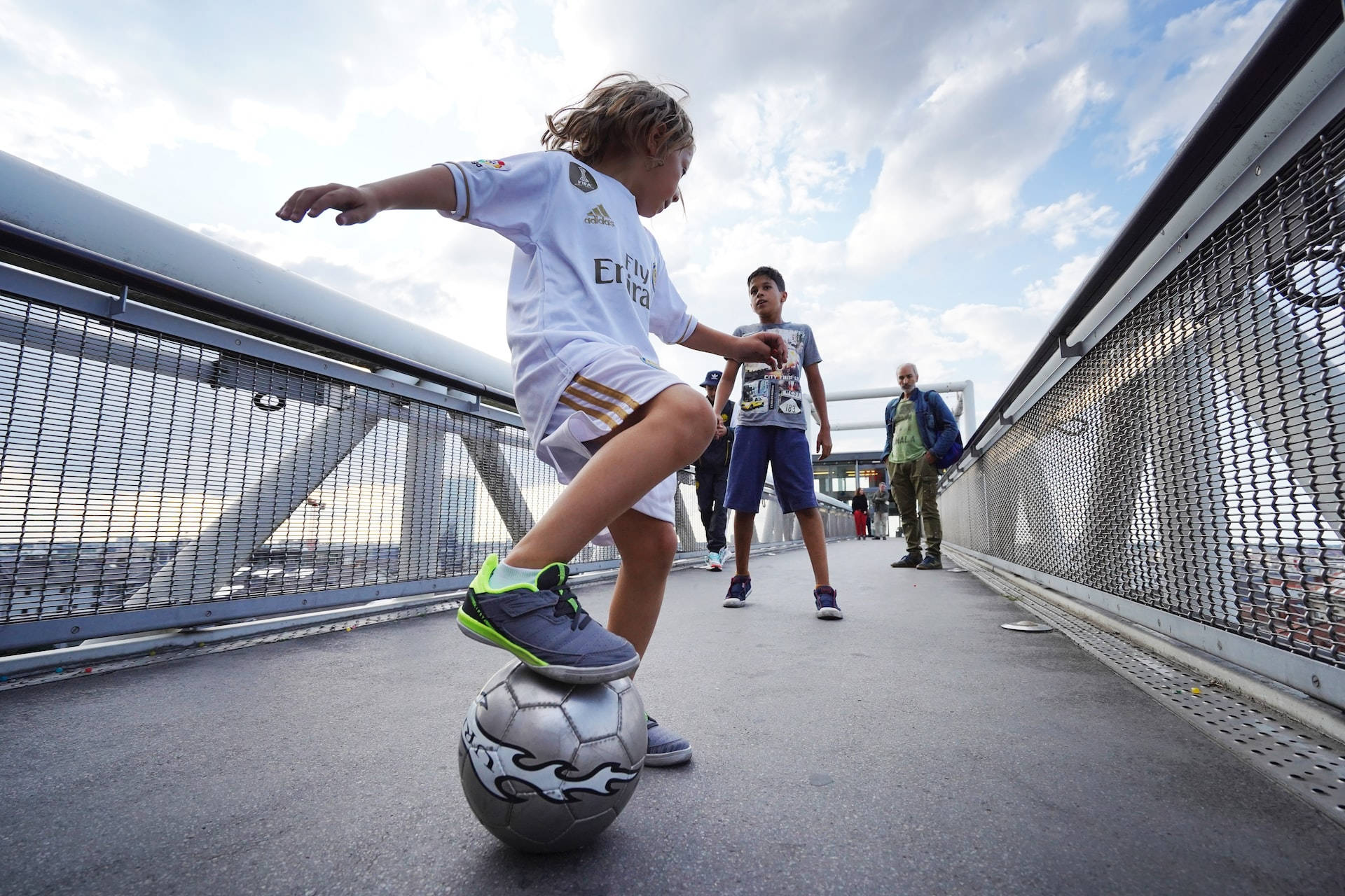 Child On A Bridge Playing Football Hd Background