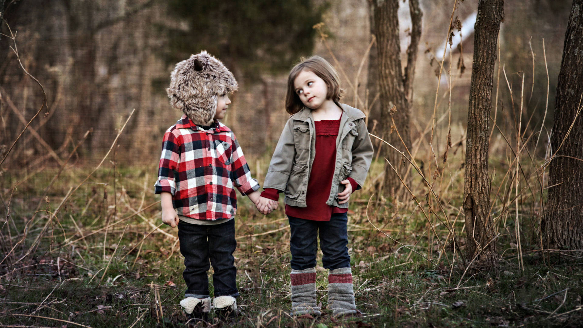 Children Holding Hands In The Wilderness Background