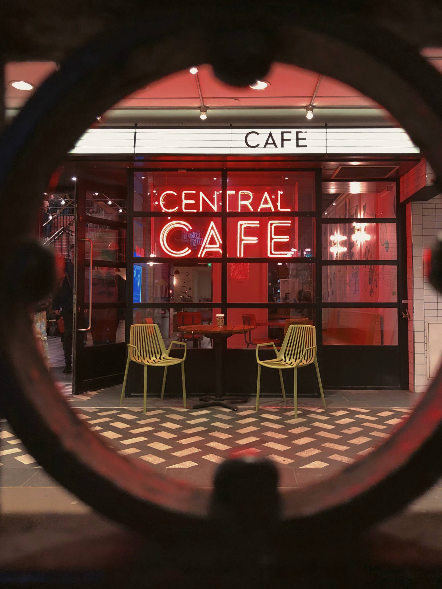 Chill Iphone Cafe With Neon Signage Background