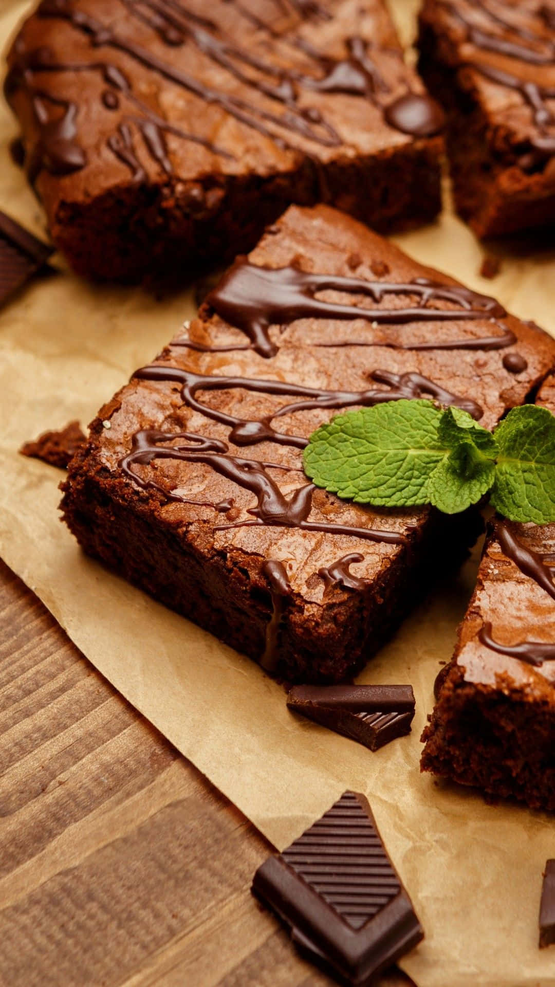 Chocolate Brownies With Mint Leaves On A Brown Paper Background
