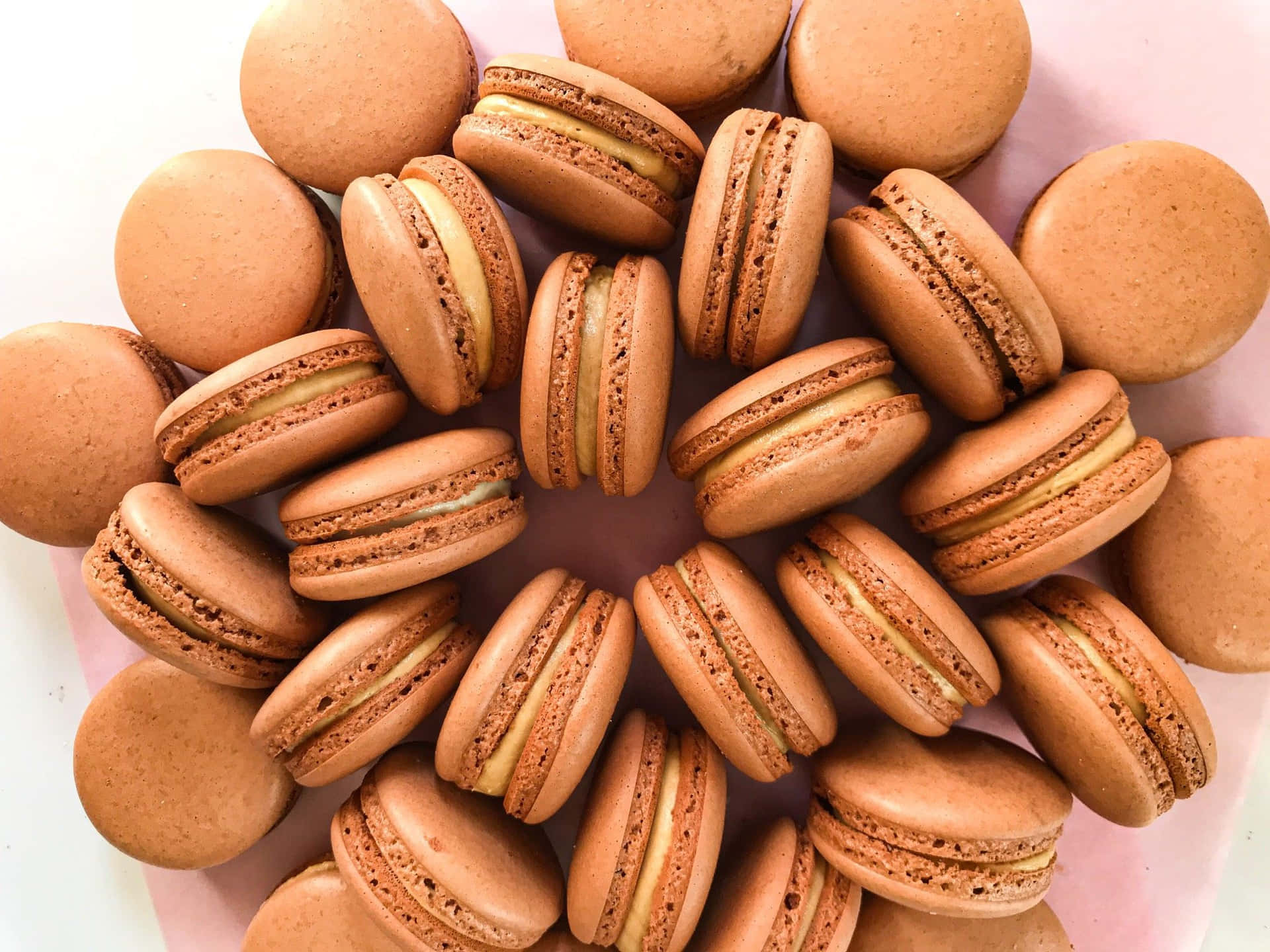 Chocolate French Macaron With Buttercream Filling Background