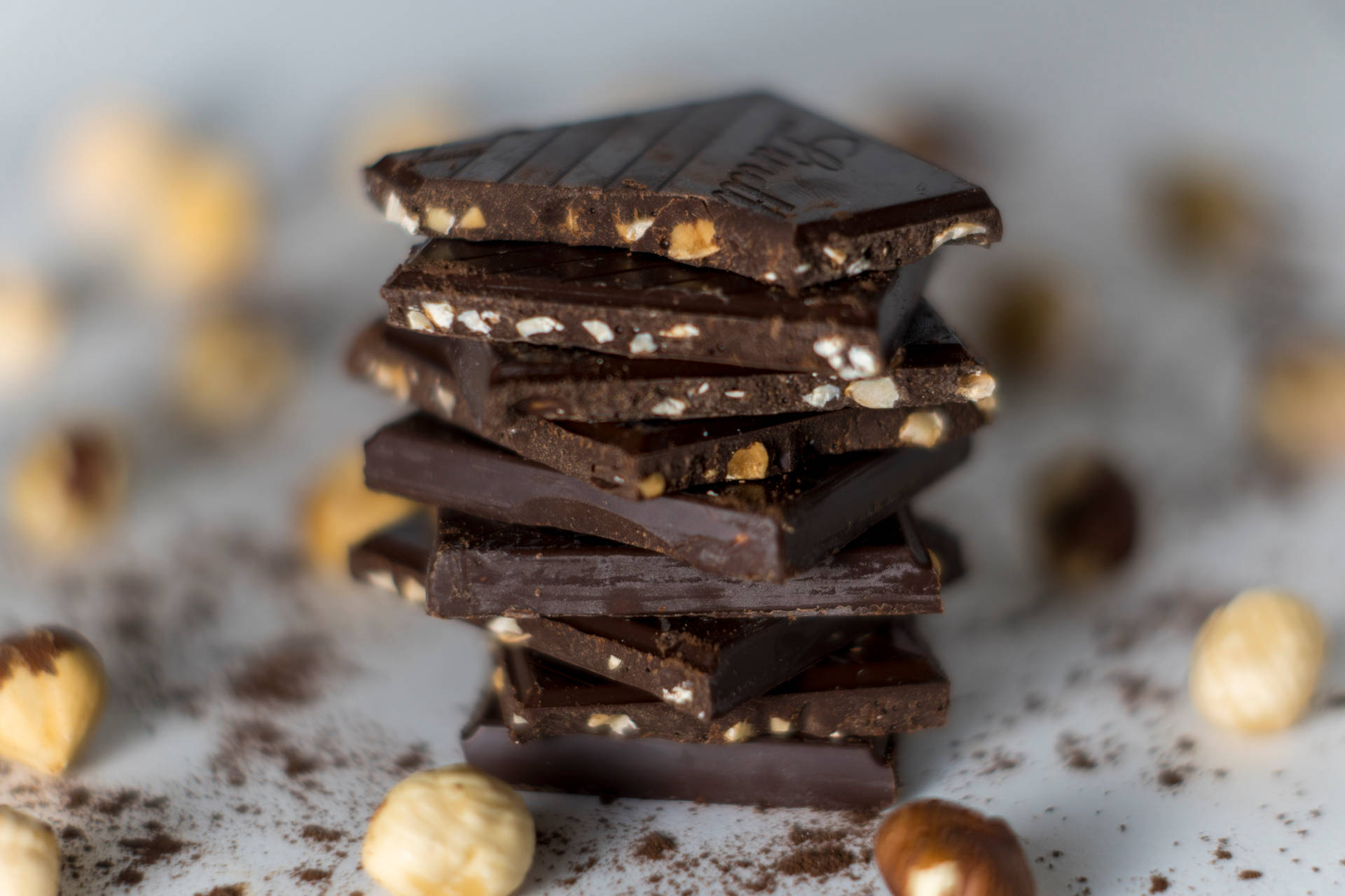 Chocolate Squares And Hazelnuts Background