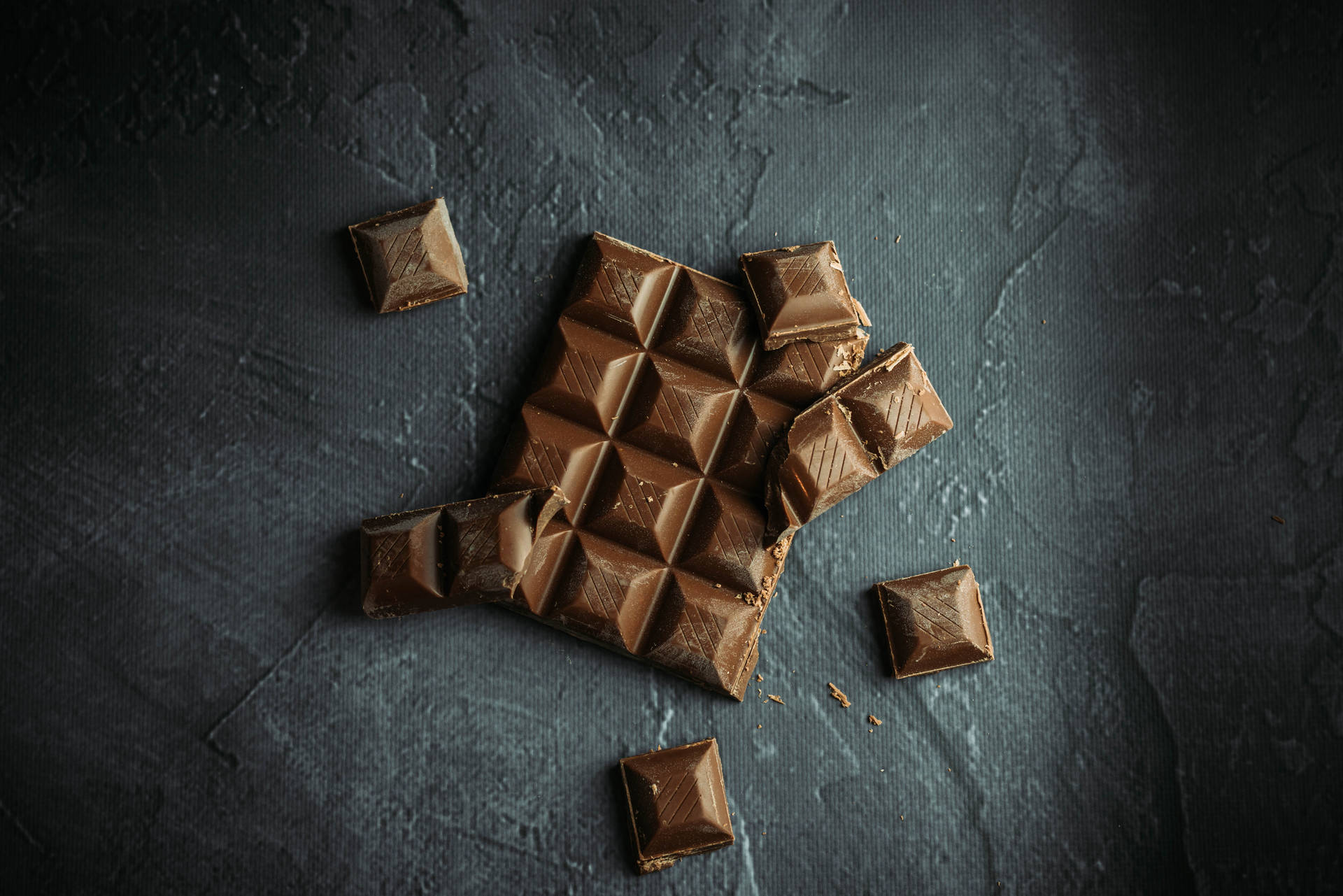 Chocolate Squares On Concrete Background