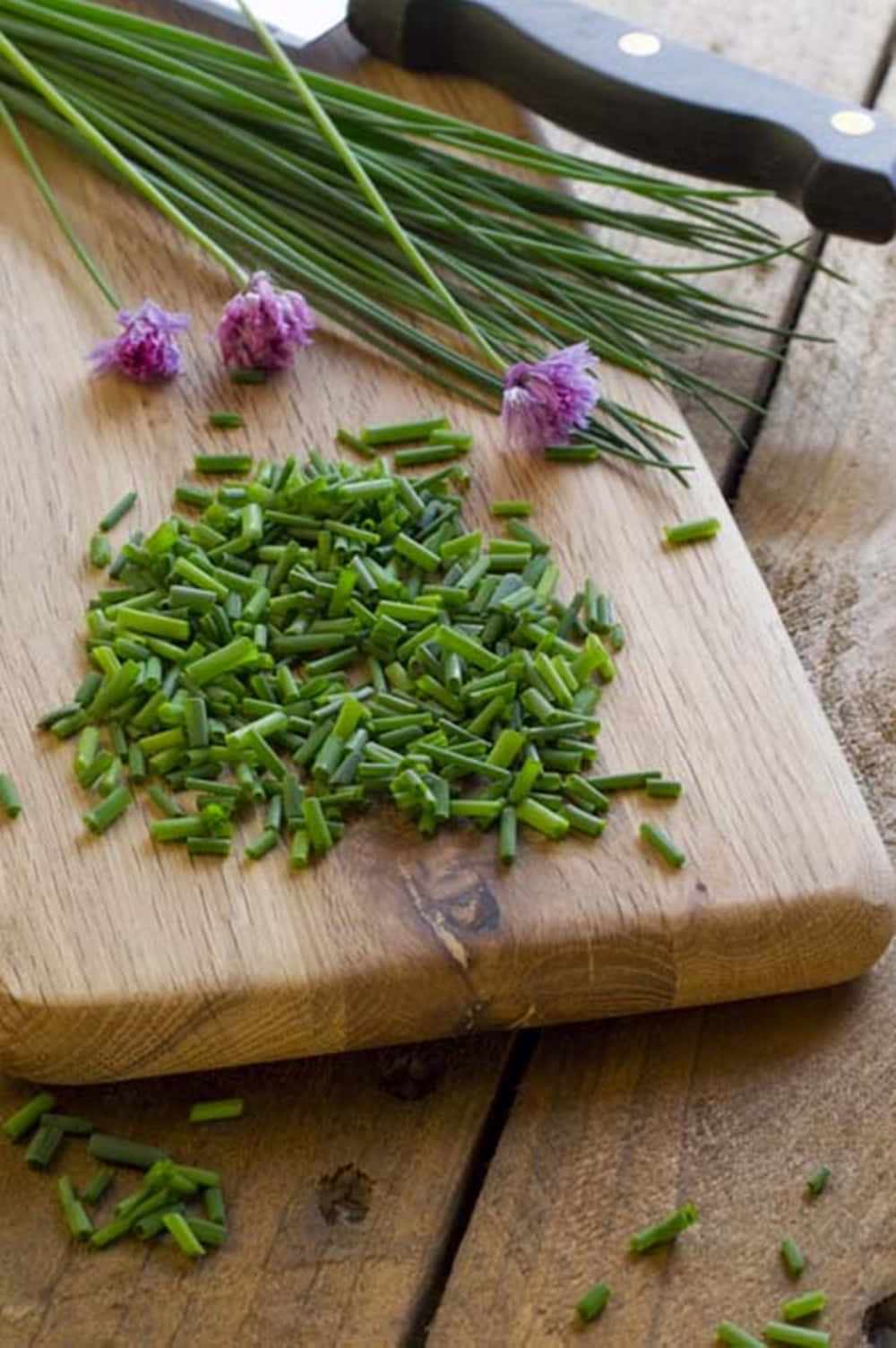 Chopped And Whole Green Chives With Purple Blossoms Background