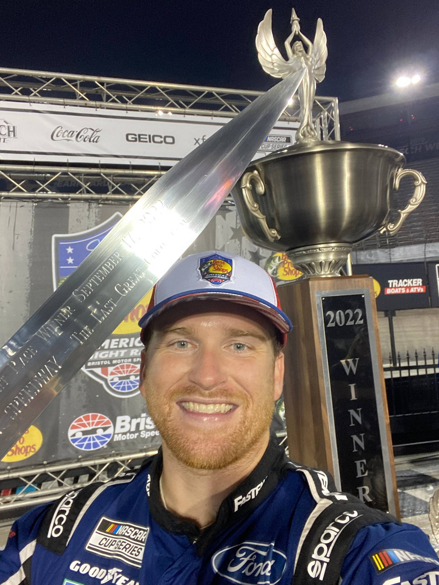 Chris Buescher Holding Championship Trophy Background