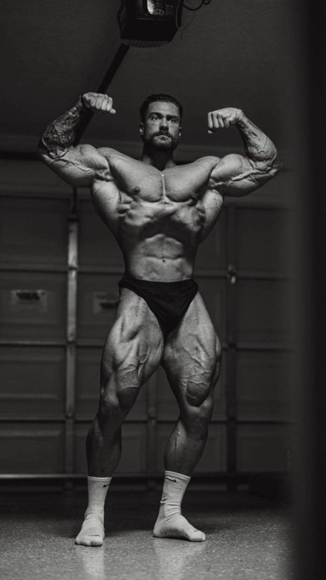 Chris Bumstead Double Front Bicep Pose Background
