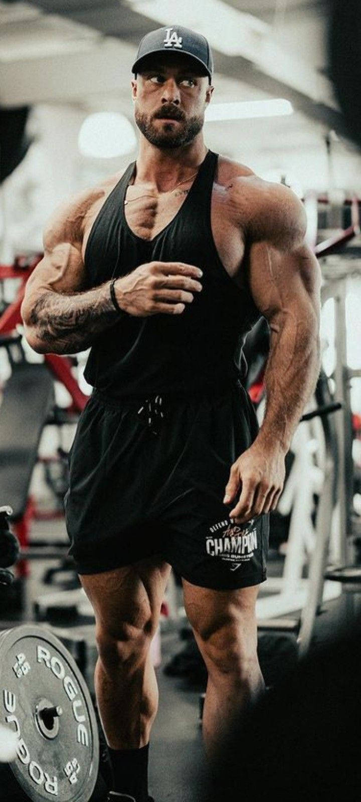 Chris Bumstead Looking At His Side Background