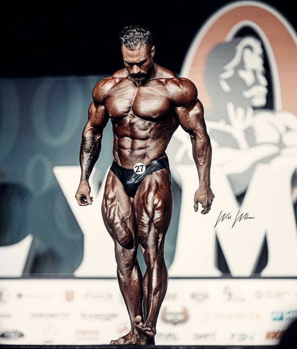 Chris Bumstead Looking Down On Stage Background