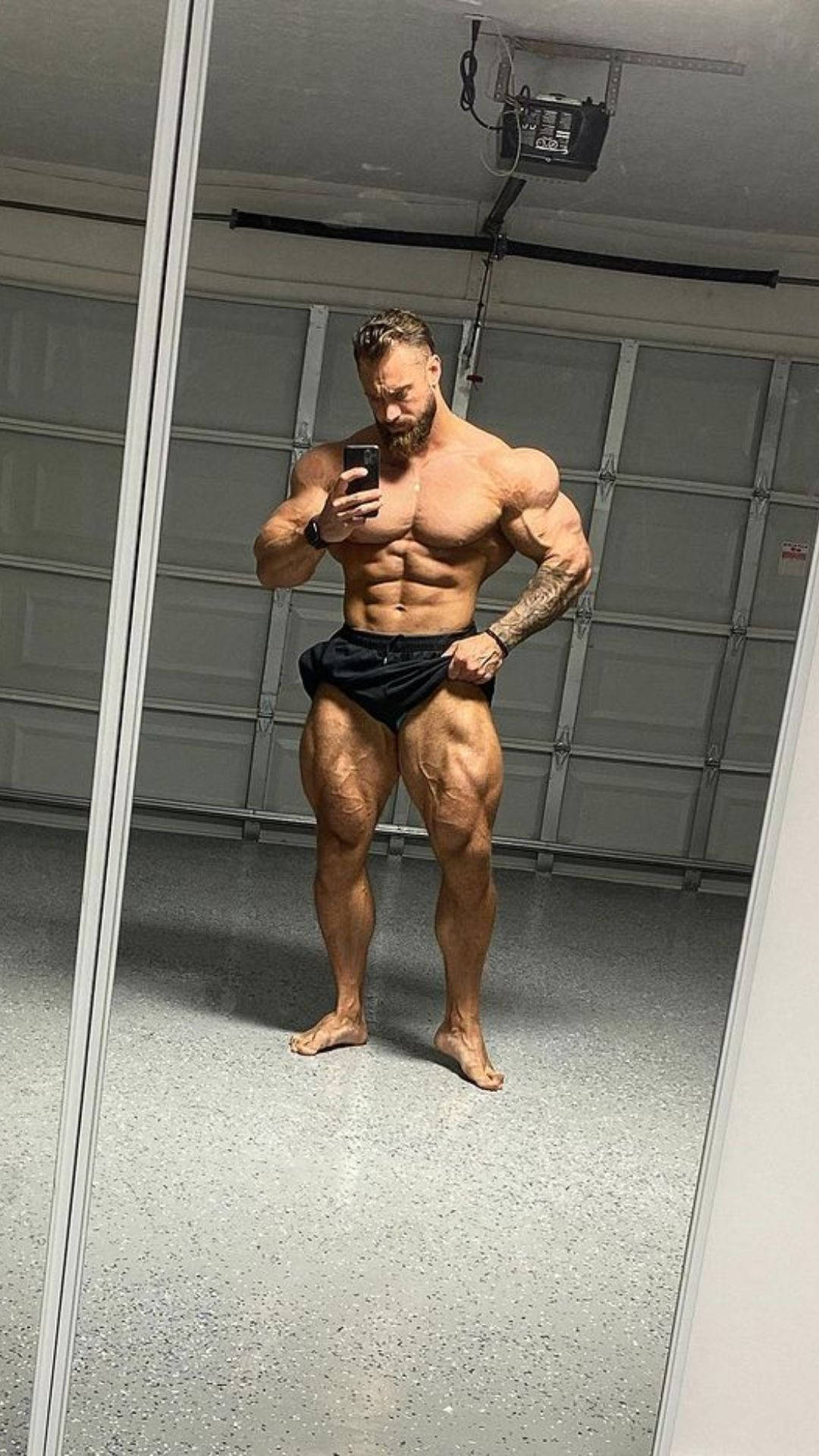 Chris Bumstead Taking A Mirror Selfie Background