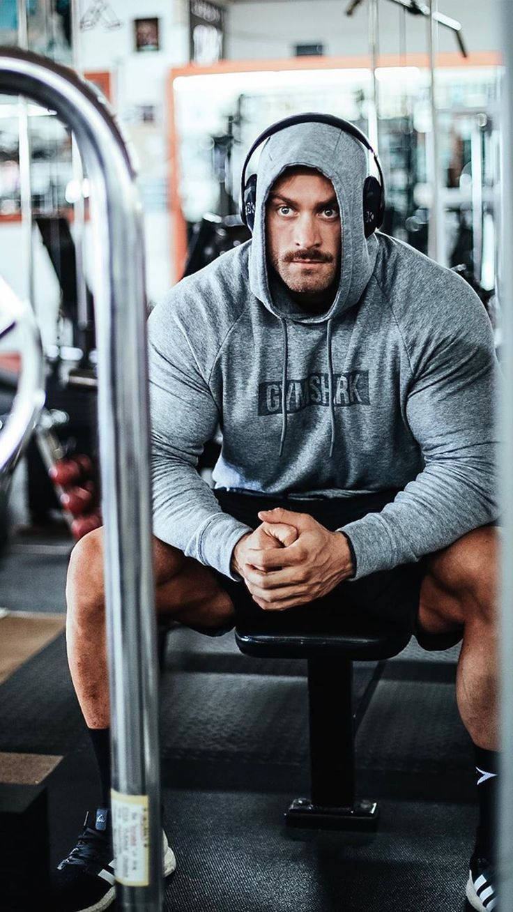 Chris Bumstead With Gray Hoodie Background