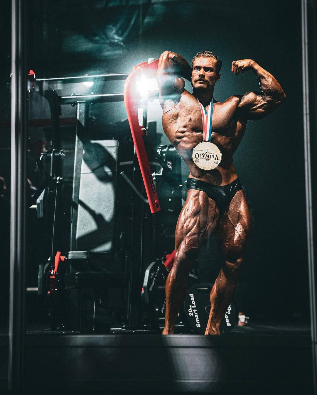 Chris Bumstead With Olympia Medal Background