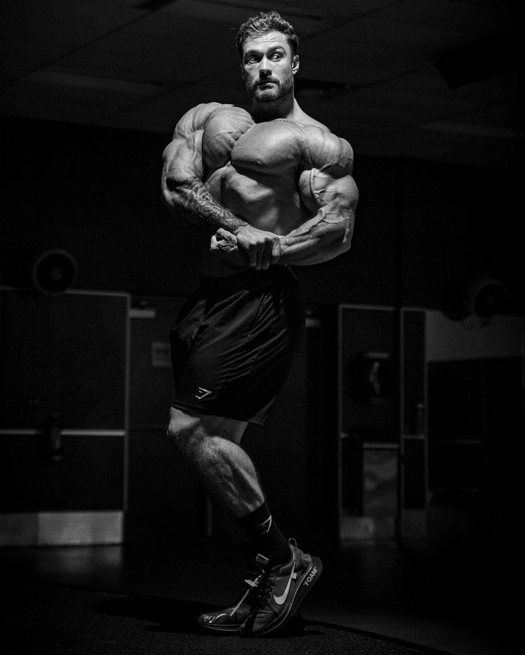 Chris Bumstead With Side Chest Pose Background
