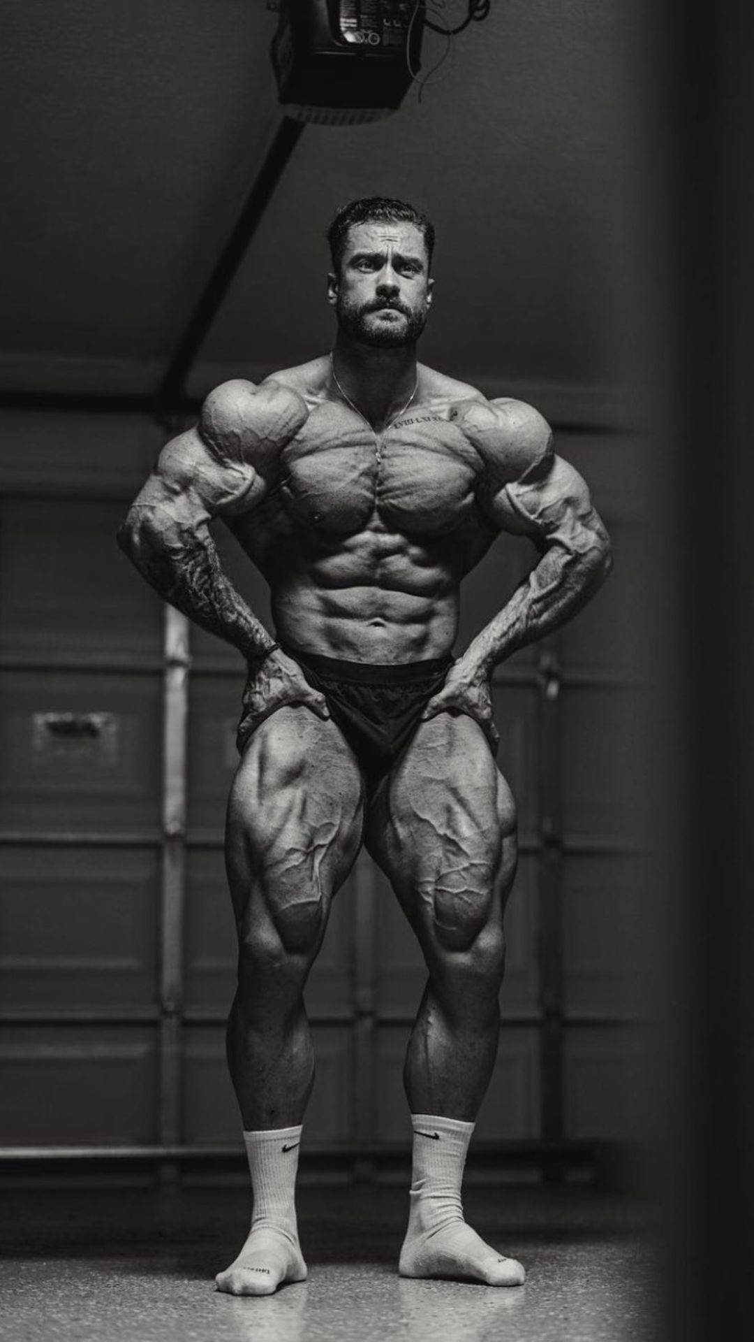 Chris Bumstead With Veins Popping Out Background