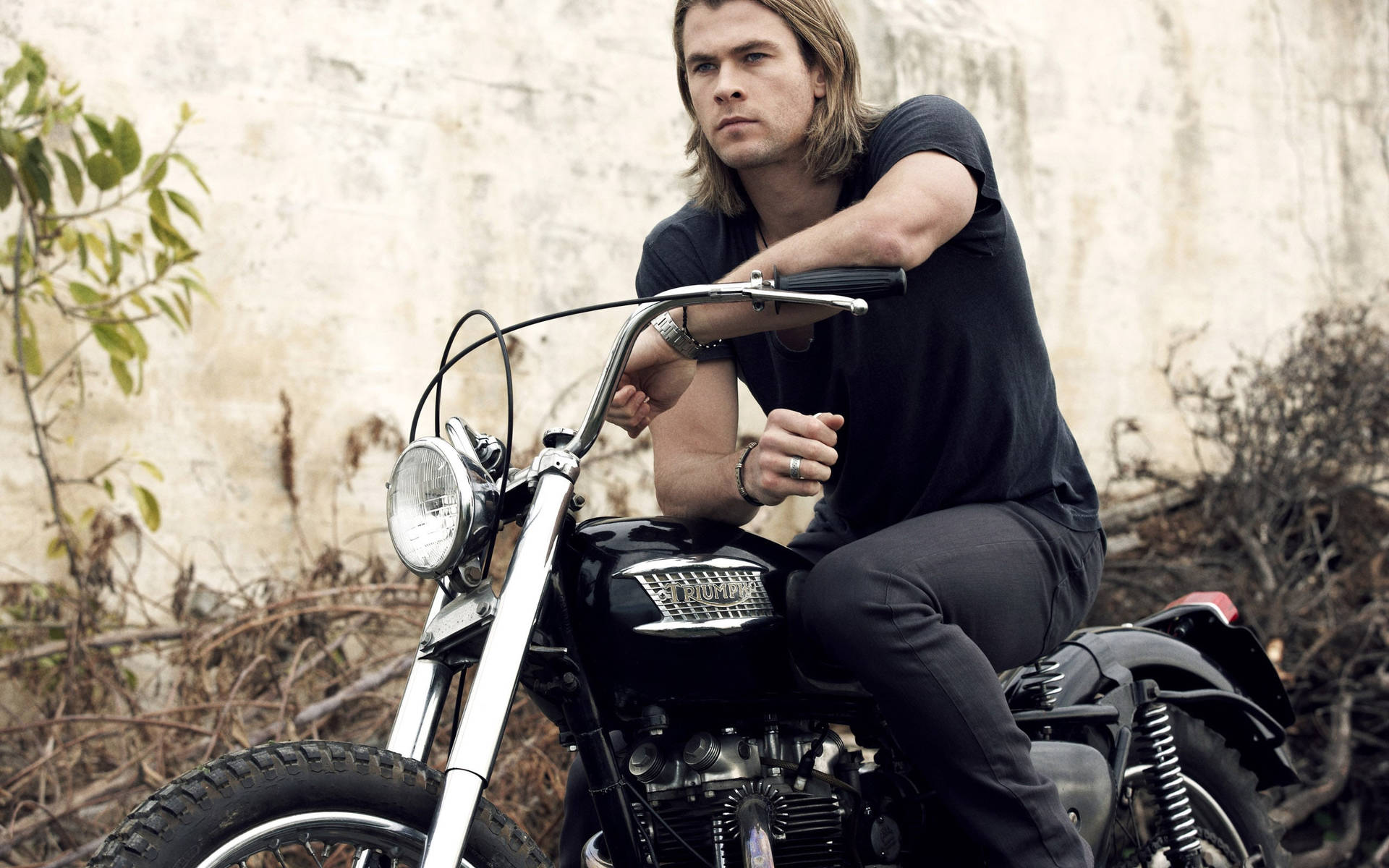 Chris Hemsworth Cruises On His Motorcycle Background
