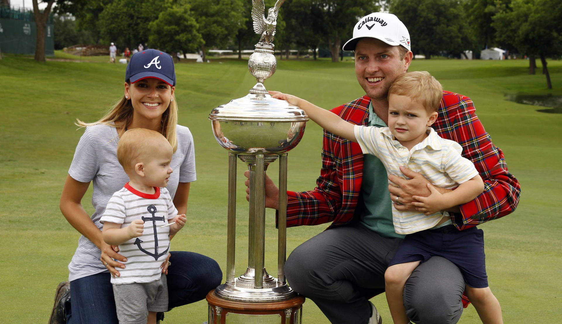 Chris Kirk With Family And Trophy Background