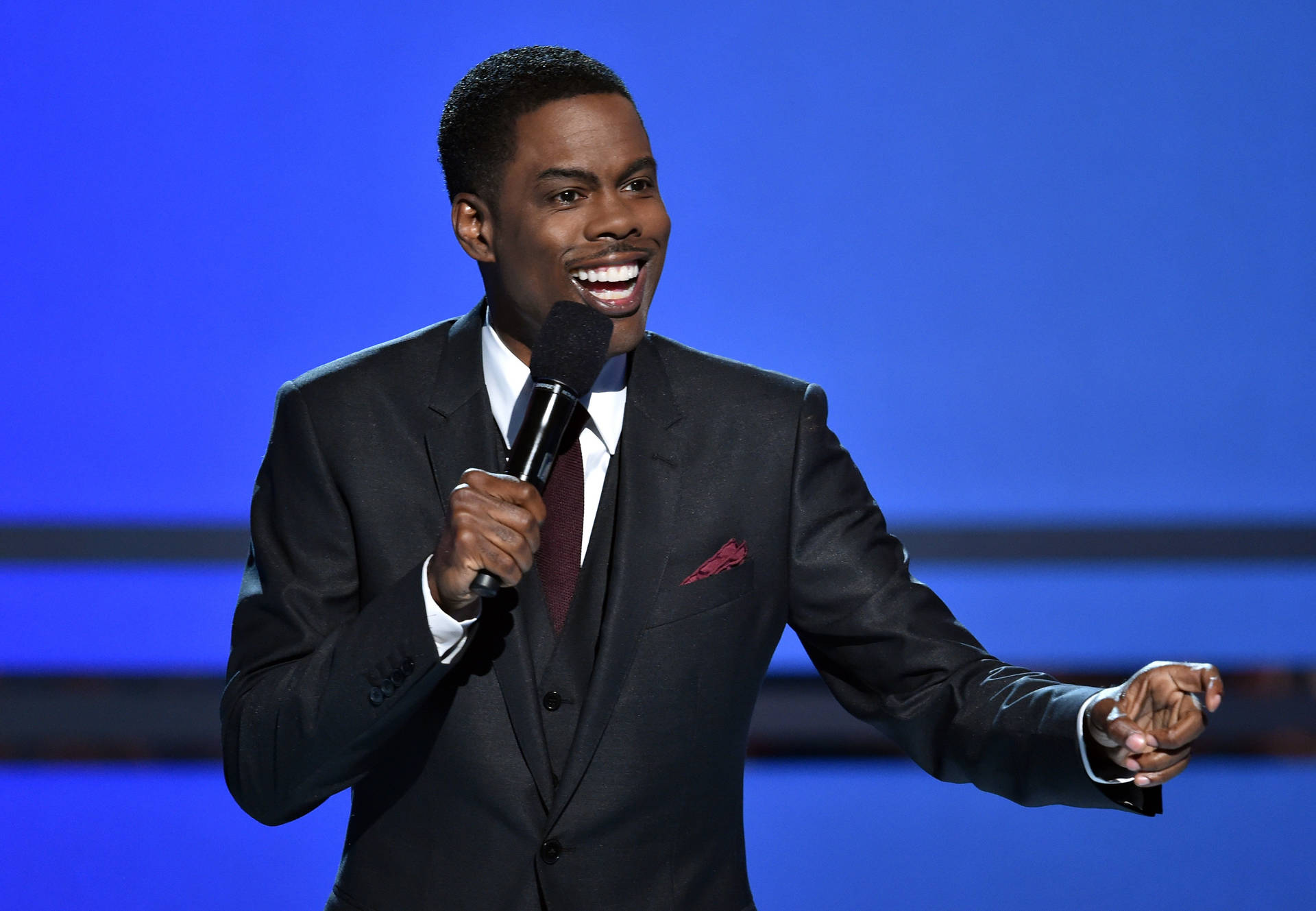 Chris Rock Delivering A Stand-up Performance Background
