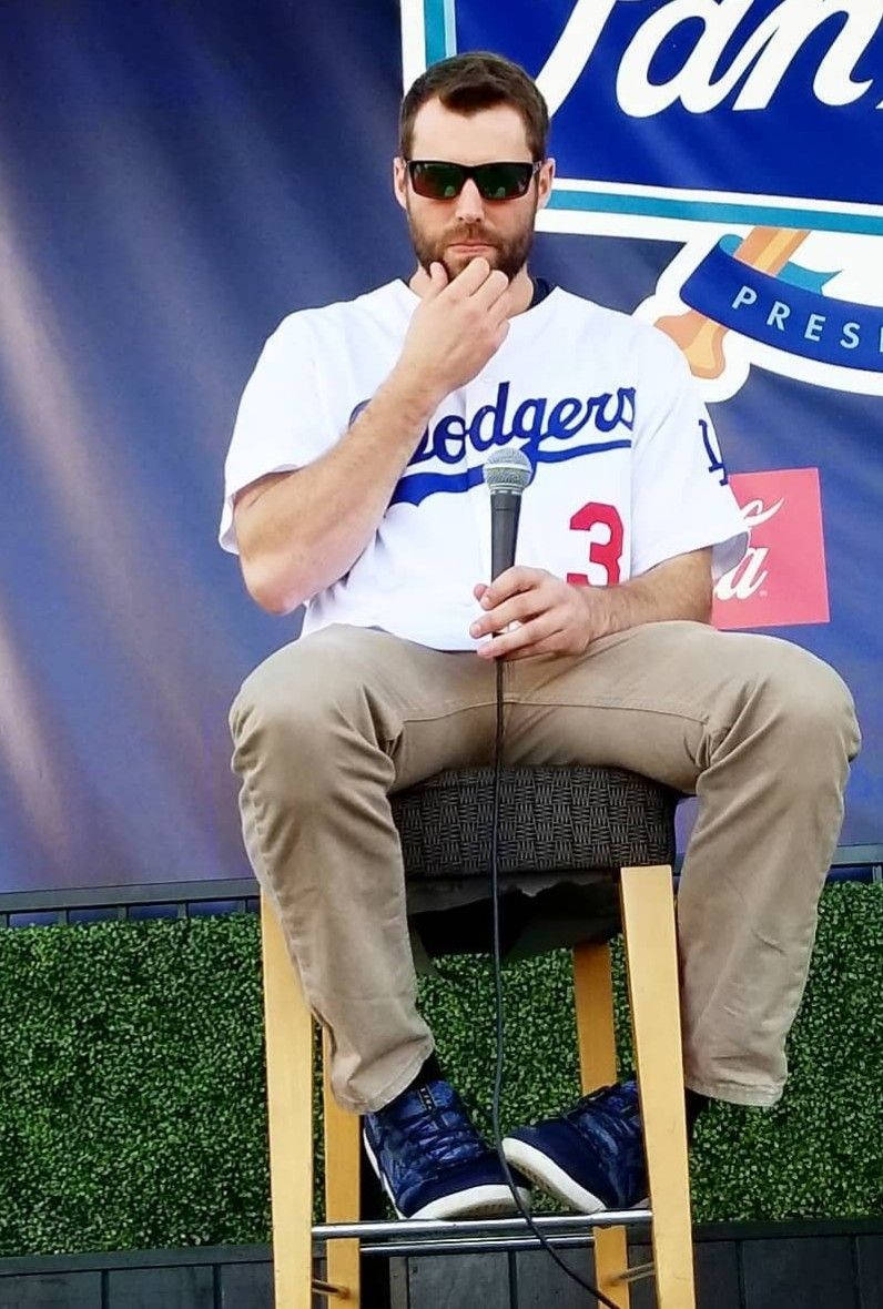 Chris Taylor Sitting Holding A Mic