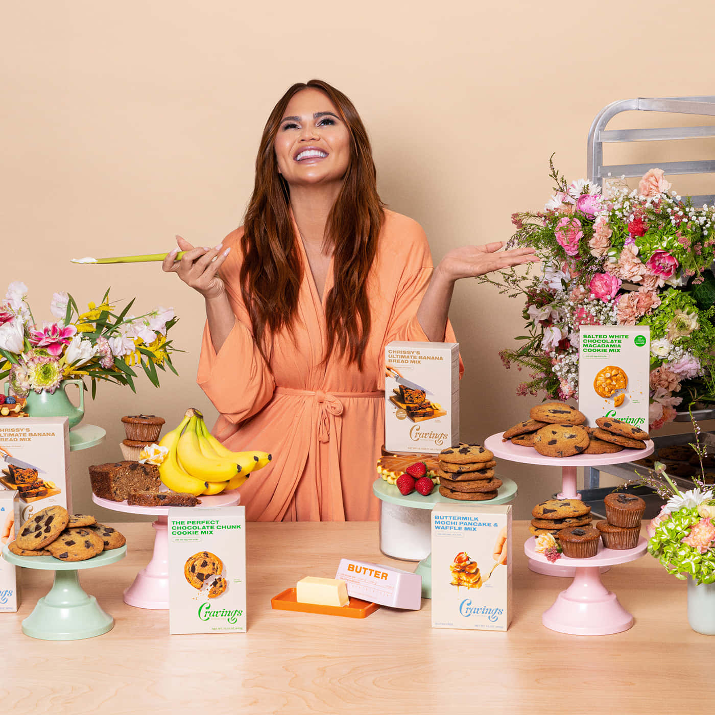 Chrissy Teigen Celebrating Baked Goods Background