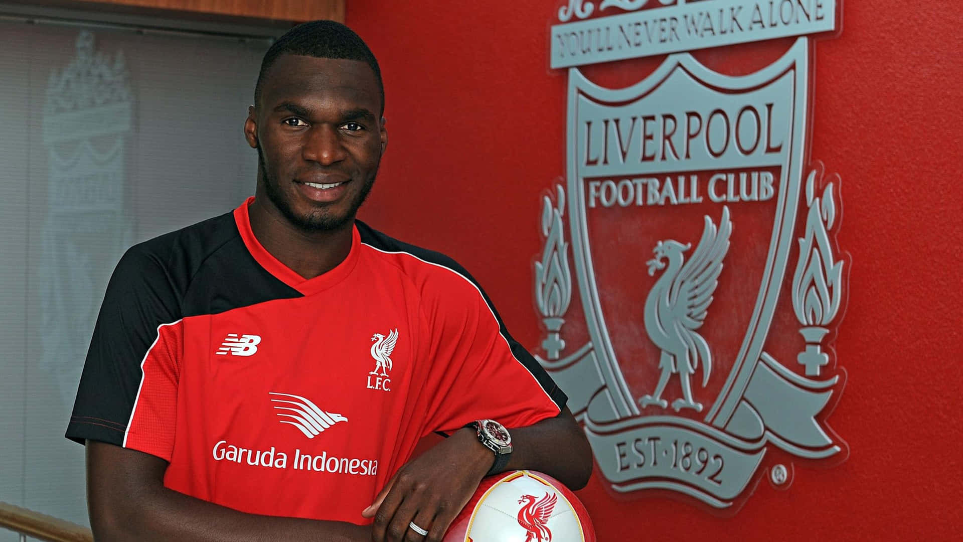 Christian Benteke Against Liverpool Fc Logo Background