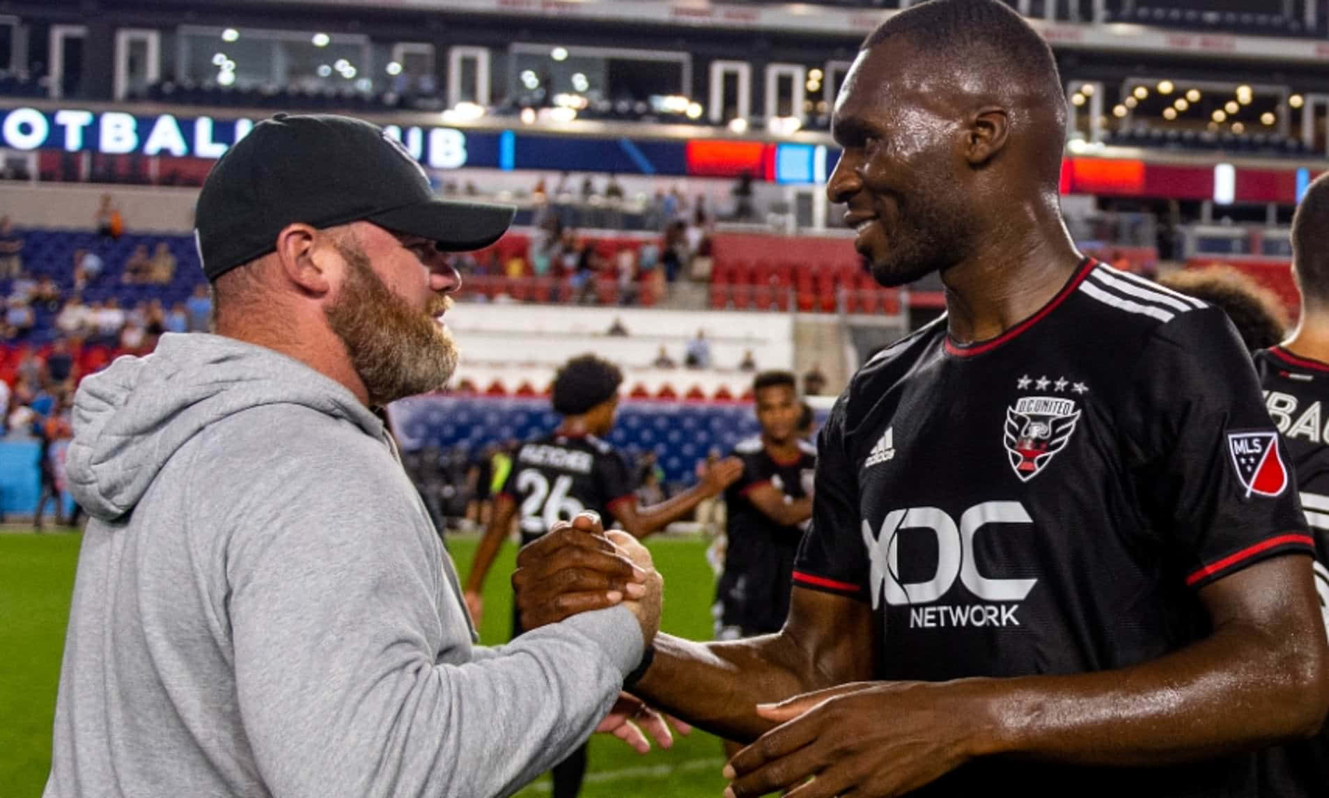 Christian Benteke Shaking Hands With Wayne Rooney Background