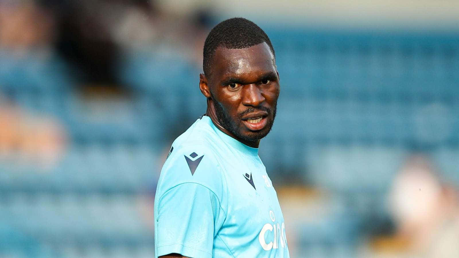 Christian Benteke Wearing Light Blue Jersey Background