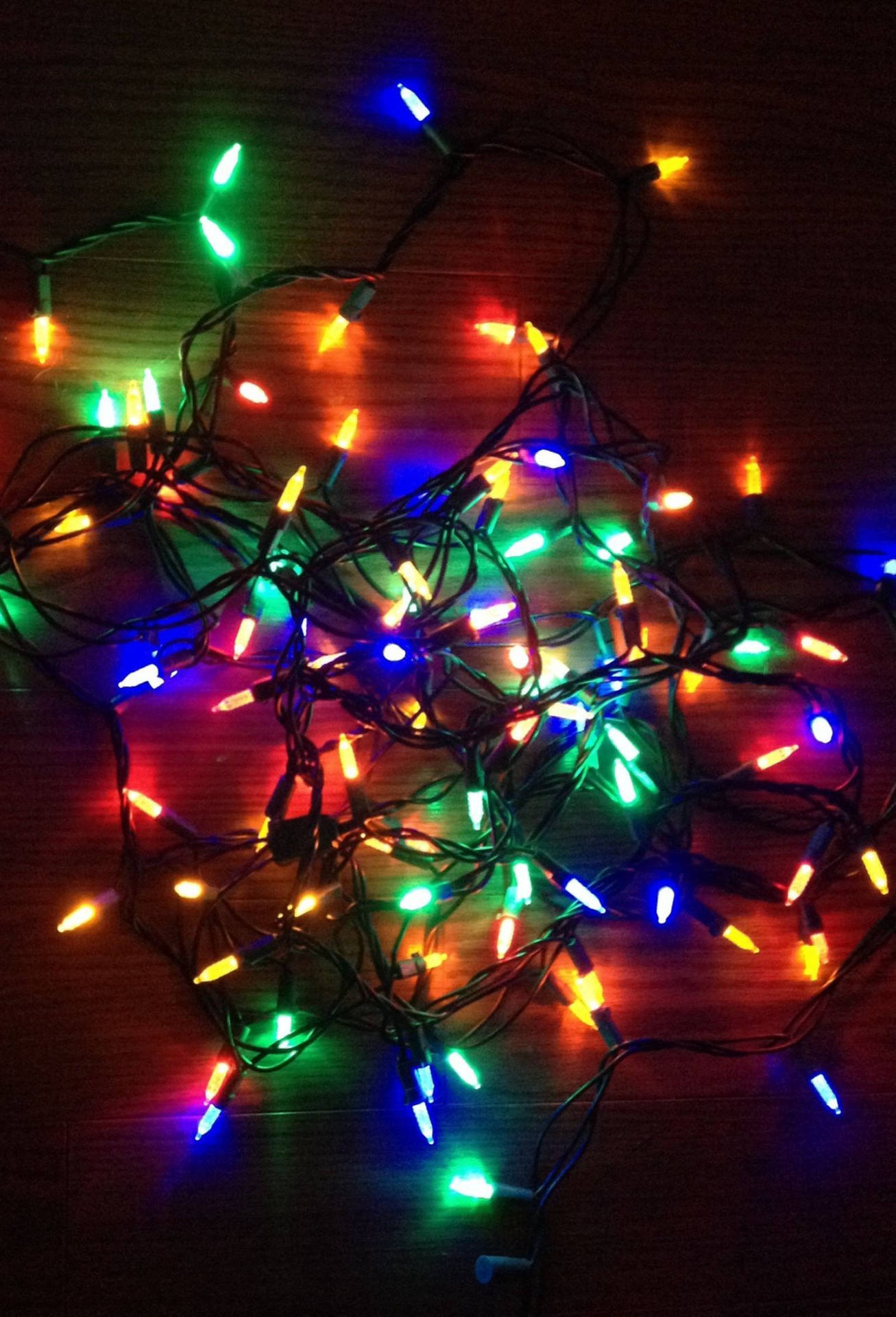 Christmas Lights On A Wooden Table Background