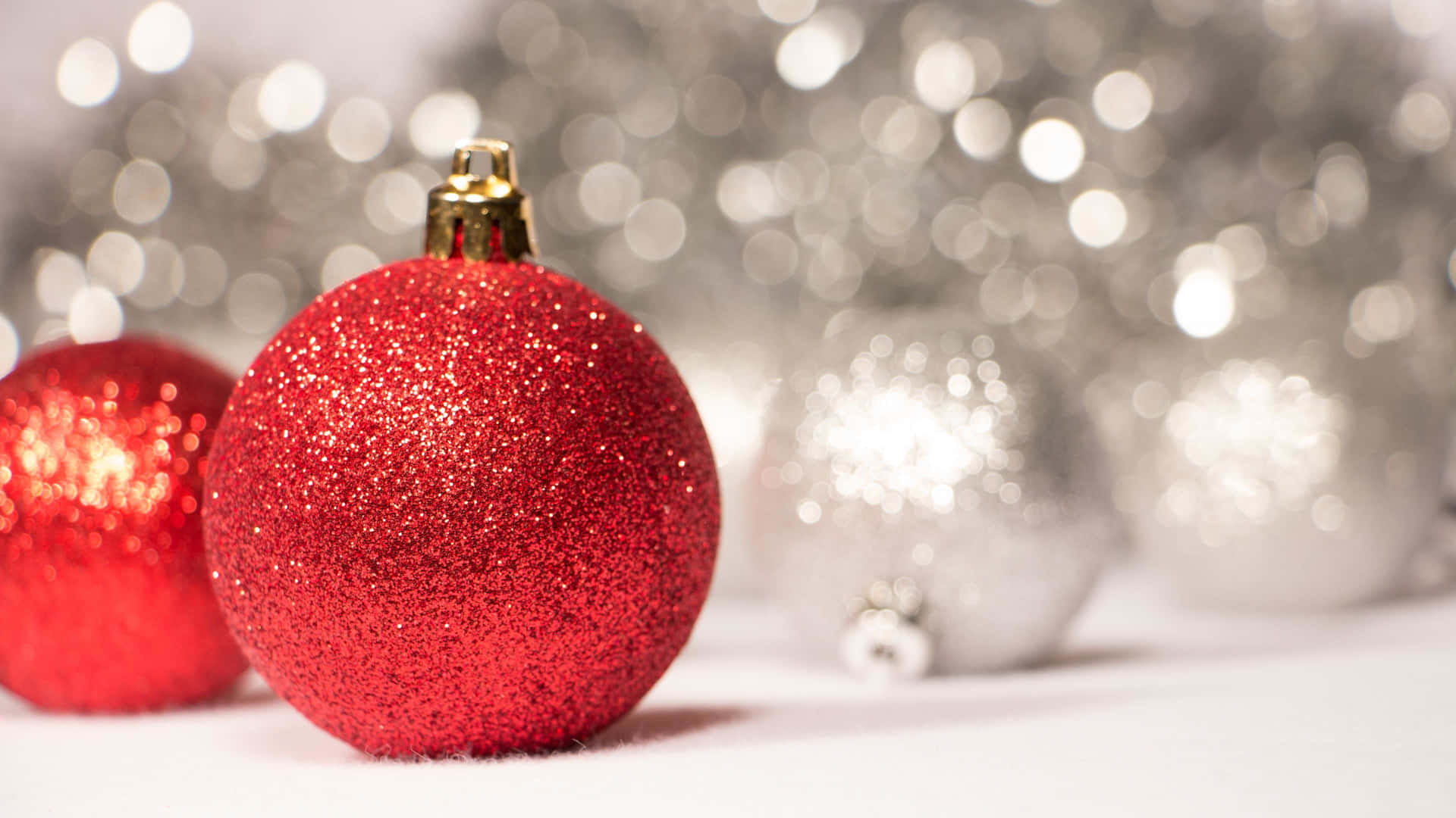 Christmas Ornaments On A White Background With Silver And Red Lights Background