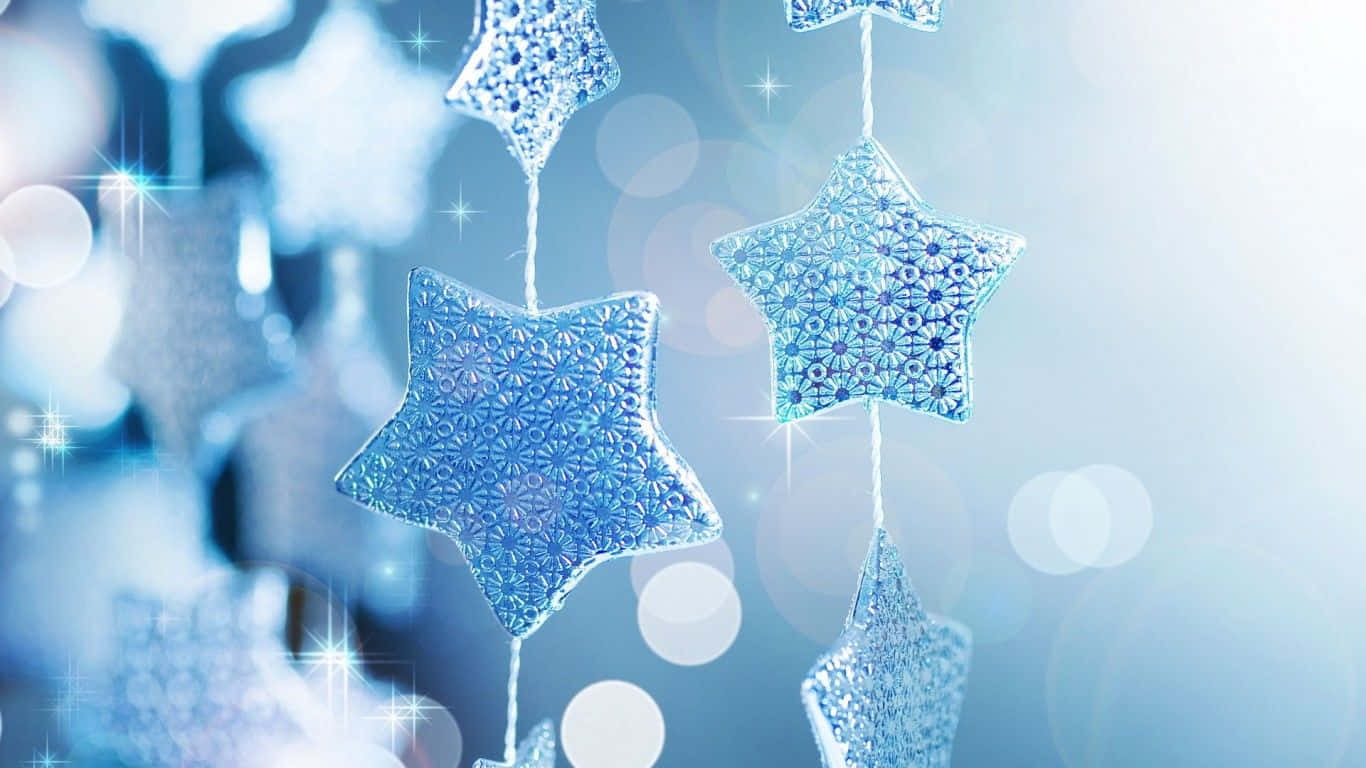 Christmas Star Decorations Hanging From A Blue Background Background