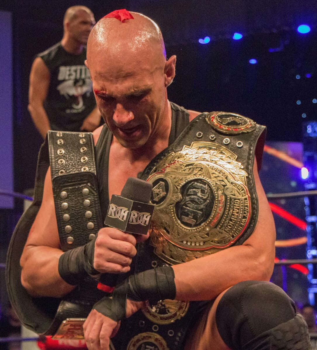 Christopher Daniels Triumphantly Holding The Roh Championship Belt Background