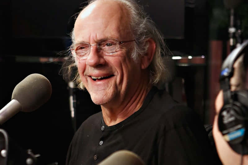 Christopher Lloyd Smiling During Interview Background