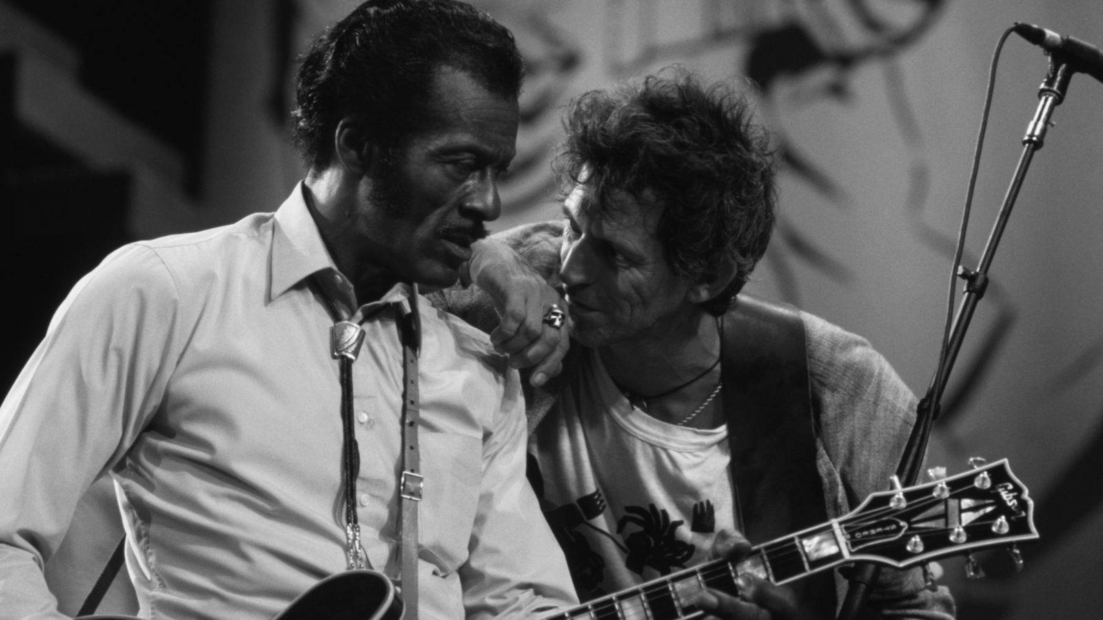 Chuck Berry And Keith Richard Sharing A Musical Moment Background