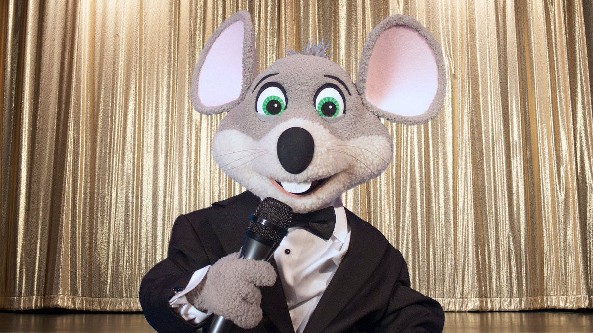 Chuck E Cheese Mascot In Suit Background